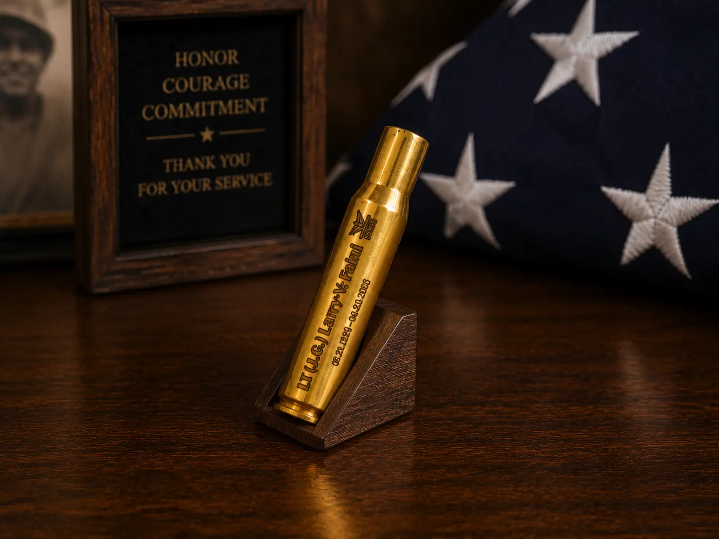 Engraved and gold-plated .30-06 shell casing displayed upright on a stand